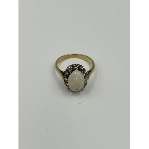 2134A - An 18ct gold opal and diamond halo ring, size M½ - approx. gross weight 4g