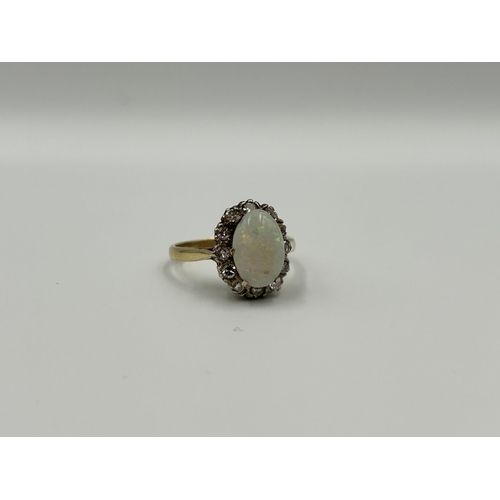 2134A - An 18ct gold opal and diamond halo ring, size M½ - approx. gross weight 4g