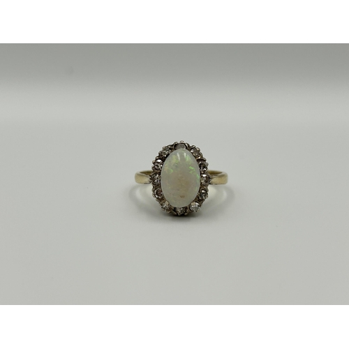 2134A - An 18ct gold opal and diamond halo ring, size M½ - approx. gross weight 4g