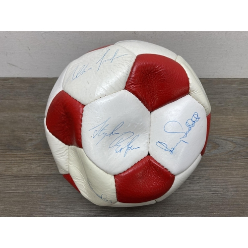 511 - A signed Stoke City Football Club football and autograph album to include signatures by Gordon Banks... 