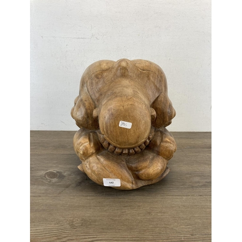 542 - A carved wooden Weeping Buddha figurine