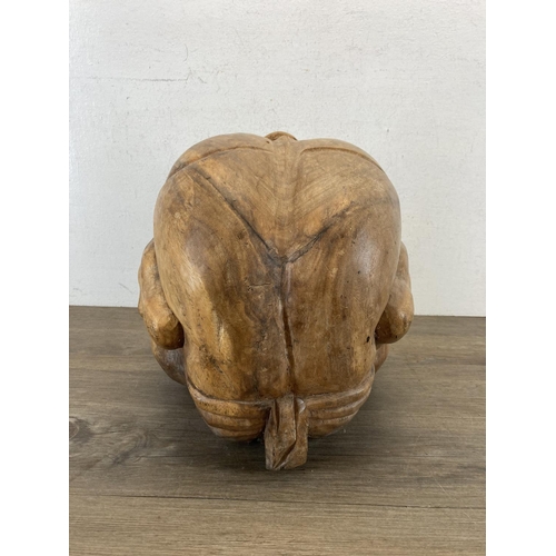 542 - A carved wooden Weeping Buddha figurine