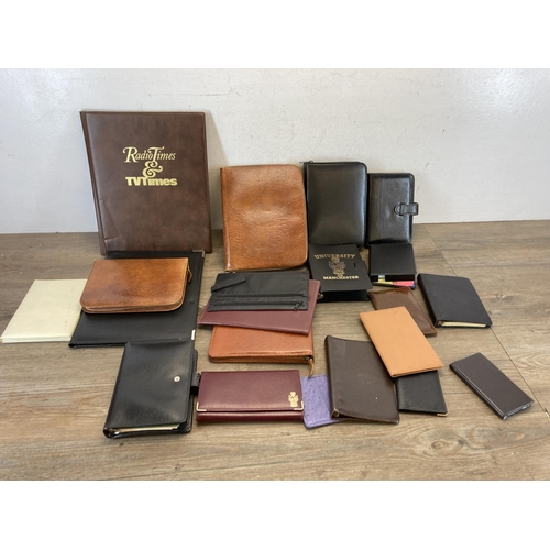 544 - A collection of leather and leatherette accessories to include notebook, clipboard holder, wallets e... 