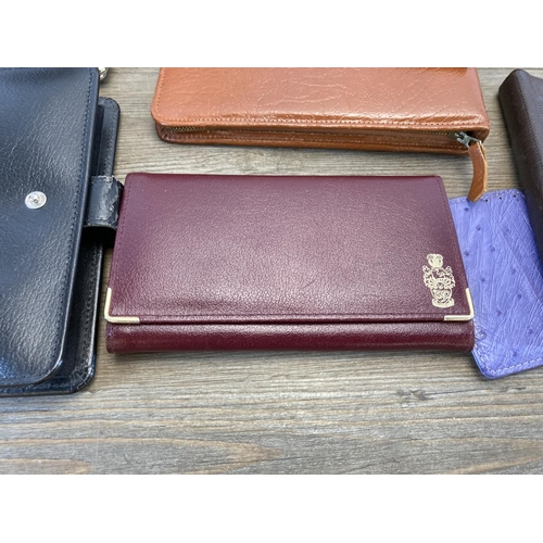 544 - A collection of leather and leatherette accessories to include notebook, clipboard holder, wallets e... 