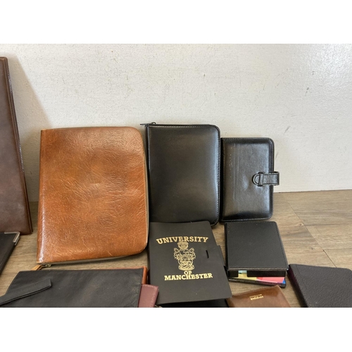 544 - A collection of leather and leatherette accessories to include notebook, clipboard holder, wallets e... 