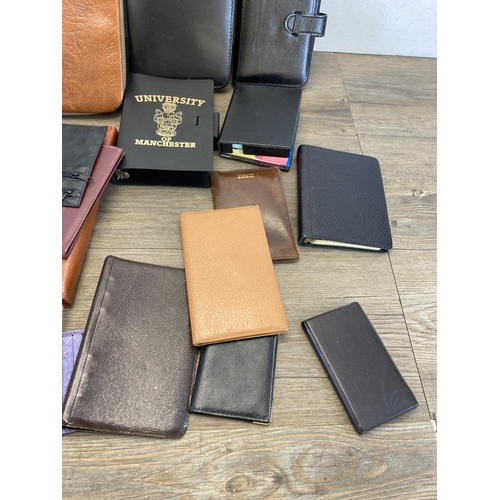 544 - A collection of leather and leatherette accessories to include notebook, clipboard holder, wallets e... 