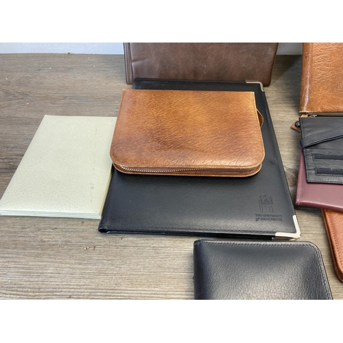 544 - A collection of leather and leatherette accessories to include notebook, clipboard holder, wallets e... 