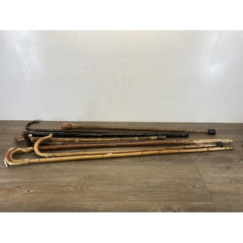 557 - Eight antique and later walking canes to include bamboo with hallmarked Birmingham silver ferule, an... 