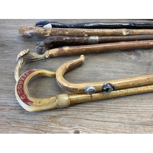 557 - Eight antique and later walking canes to include bamboo with hallmarked Birmingham silver ferule, an... 