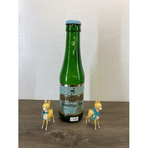 564 - Three mid 20th century Babycham advertising collectables, one green glass money bottle and two plast... 