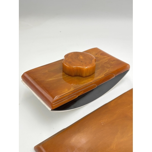 2255 - An Art Deco Carvacraft (A Dickinson Product) amber Bakelite notepad holder and ink blotter