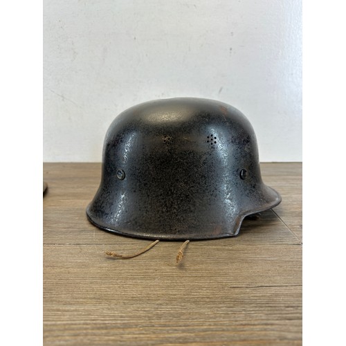 2269 - Two German helmets, one M34 Fire Police and one post war