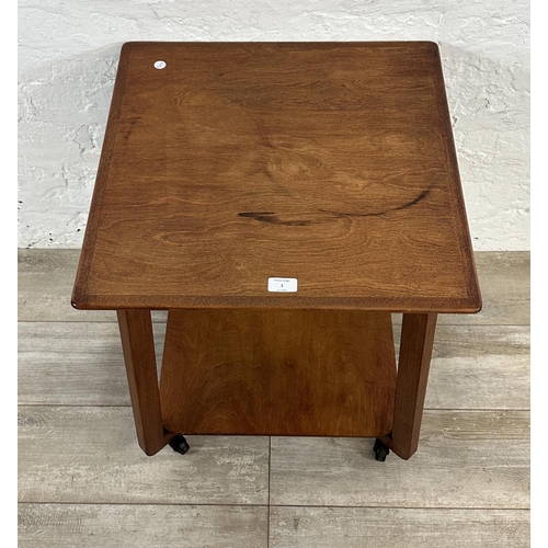 1 - A mid 20th century teak two tier serving trolley - approx. 60cm high x 53cm wide x 53cm deep