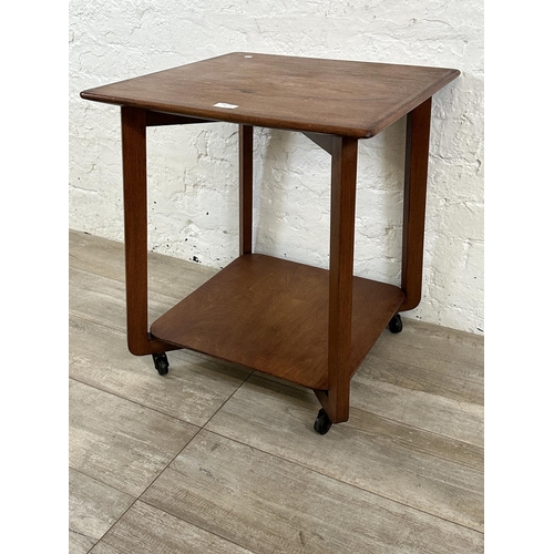 1 - A mid 20th century teak two tier serving trolley - approx. 60cm high x 53cm wide x 53cm deep