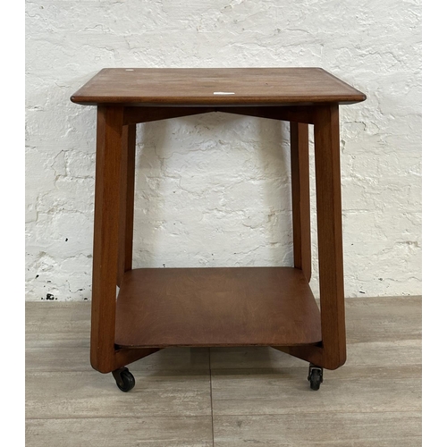 1 - A mid 20th century teak two tier serving trolley - approx. 60cm high x 53cm wide x 53cm deep