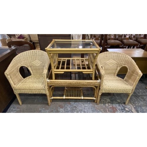 105 - Four pieces of wicker and cane furniture, two glass top coffee tables and two armchairs