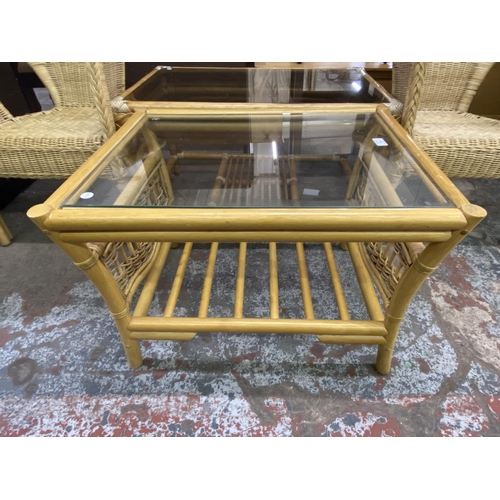 105 - Four pieces of wicker and cane furniture, two glass top coffee tables and two armchairs