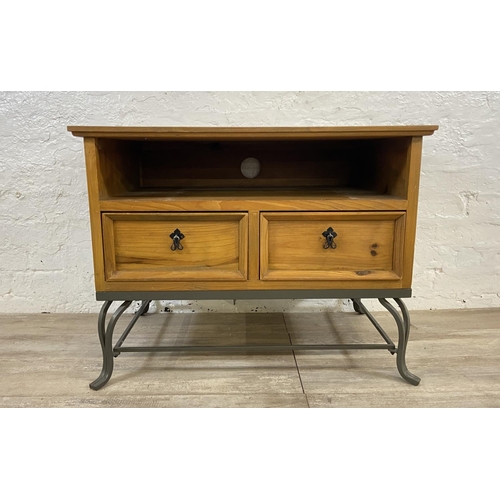 110A - A Mexican pine and wrought iron two drawer TV stand - approx. 61cm high x 80cm wide x 55cm deep