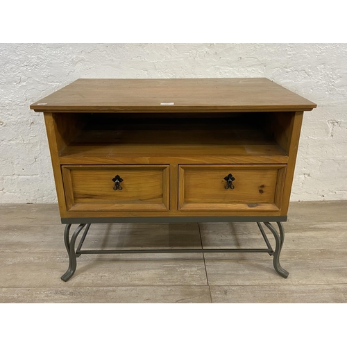 110A - A Mexican pine and wrought iron two drawer TV stand - approx. 61cm high x 80cm wide x 55cm deep