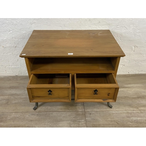 110A - A Mexican pine and wrought iron two drawer TV stand - approx. 61cm high x 80cm wide x 55cm deep