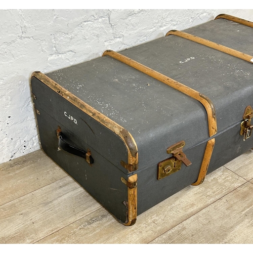 12 - A mid 20th century blue painted compressed fibre and beech banded travel trunk monogramed 