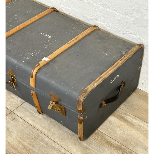 12 - A mid 20th century blue painted compressed fibre and beech banded travel trunk monogramed 