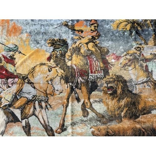 13 - Two woven items, one wall hanging depicting lion hunt - approx. 115cm high x 167cm and one velvet pr... 