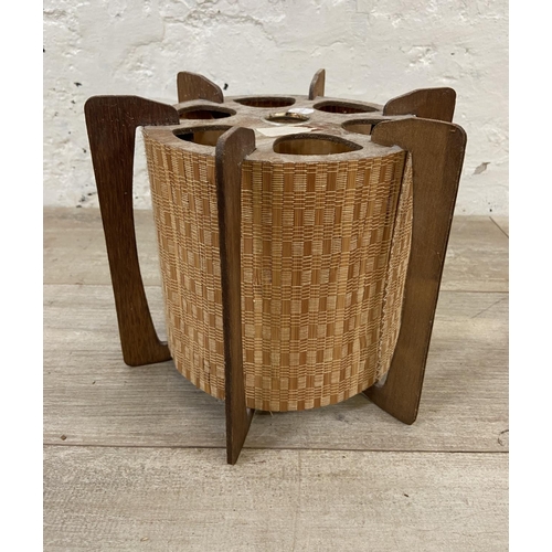 147 - Two lighting items, one mid 20th century teak and wicker light shade and one Terence Conran style de... 