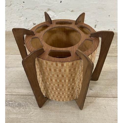 147 - Two lighting items, one mid 20th century teak and wicker light shade and one Terence Conran style de... 