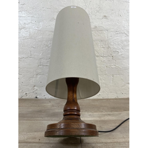 177 - A mid 20th century inlaid oak table lamp on circular base - approx. 80cm high including shade