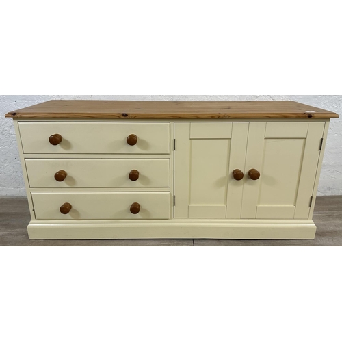 184 - A modern pine and cream painted TV stand - approx. 62cm high x 137cm wide x 45cm deep