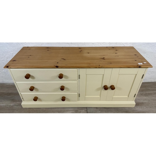 184 - A modern pine and cream painted TV stand - approx. 62cm high x 137cm wide x 45cm deep