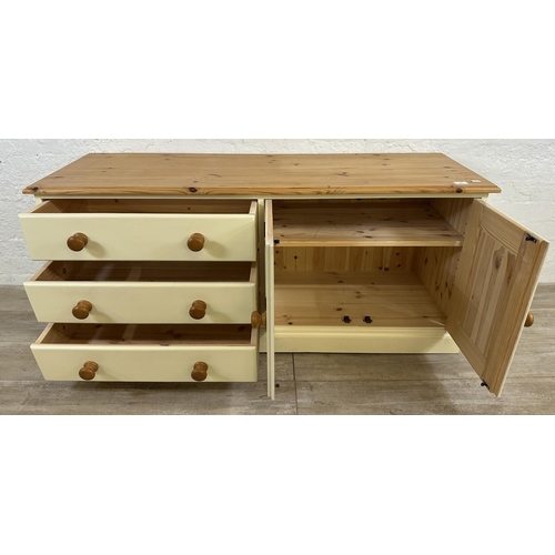 184 - A modern pine and cream painted TV stand - approx. 62cm high x 137cm wide x 45cm deep