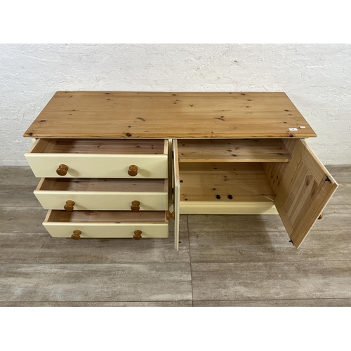 184 - A modern pine and cream painted TV stand - approx. 62cm high x 137cm wide x 45cm deep