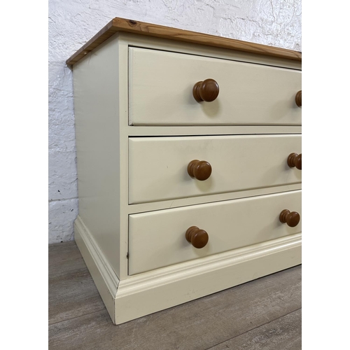 184 - A modern pine and cream painted TV stand - approx. 62cm high x 137cm wide x 45cm deep