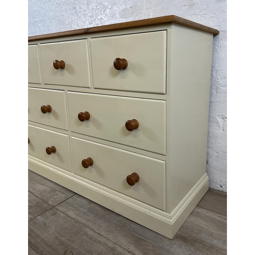 185 - A modern pine and cream painted chest of drawers - approx. 82cm high x 122cm wide x 45cm deep