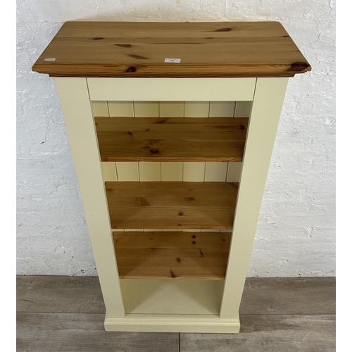 188 - A modern pine and cream painted four tier bookcase - approx. 137cm high x 66cm wide x 30cm deep