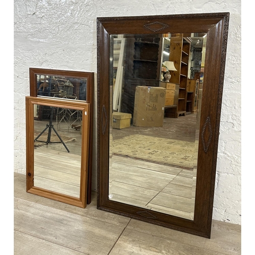 189 - Four items, one Edwardian mahogany and tapestry fire screen, and three wall mirrors, one Edwardian o... 