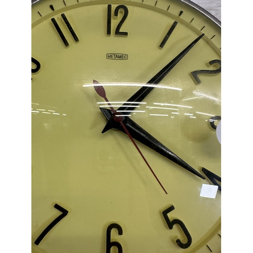 19 - A mid 20th century Metamec chrome plated and yellow plastic circular wall clock - approx. 20cm diame... 