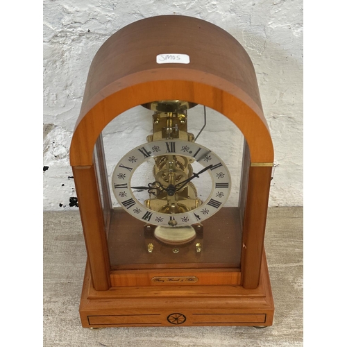 21 - A Franz Hermle & Sohn walnut effect cased key wind skeleton mantel clock with pendulum - approx. 30c... 