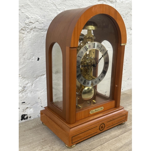 21 - A Franz Hermle & Sohn walnut effect cased key wind skeleton mantel clock with pendulum - approx. 30c... 