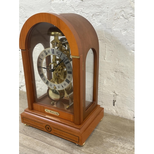 21 - A Franz Hermle & Sohn walnut effect cased key wind skeleton mantel clock with pendulum - approx. 30c... 