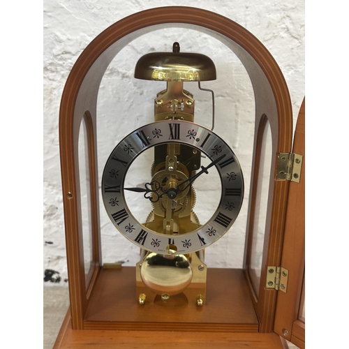 21 - A Franz Hermle & Sohn walnut effect cased key wind skeleton mantel clock with pendulum - approx. 30c... 