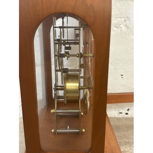 21 - A Franz Hermle & Sohn walnut effect cased key wind skeleton mantel clock with pendulum - approx. 30c... 