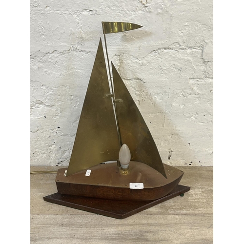 22 - A mid 20th century oak and brass novelty sailing boat table lamp - approx. 49cm high