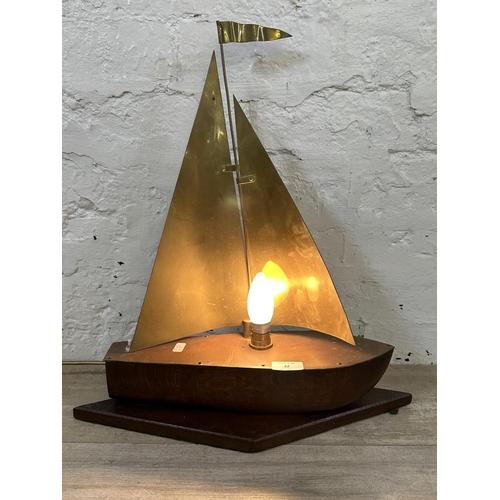 22 - A mid 20th century oak and brass novelty sailing boat table lamp - approx. 49cm high