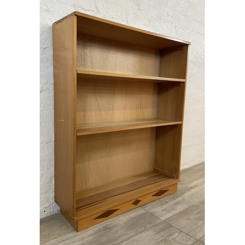 34 - A mid 20th century walnut three tier bookcase - approx. 100cm high x 83cm wide x 23cm deep