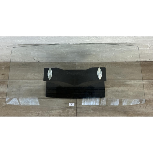 36 - A contemporary glass top coffee table on black faux leather and glass base - approx. 45cm high x 50c... 