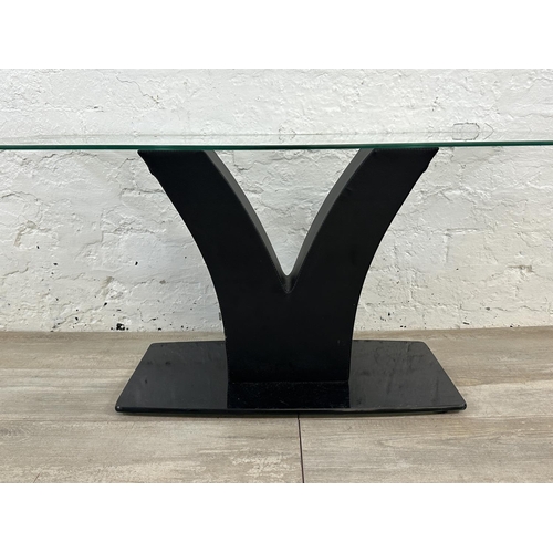 36 - A contemporary glass top coffee table on black faux leather and glass base - approx. 45cm high x 50c... 