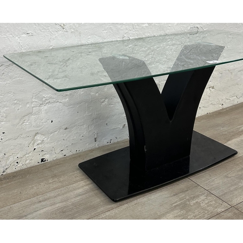 36 - A contemporary glass top coffee table on black faux leather and glass base - approx. 45cm high x 50c... 